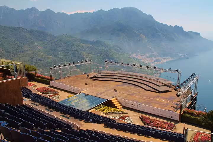 Open-air stage with scenic views of the Amalfi Coast's lush mountains and sea in Ravello, Italy.