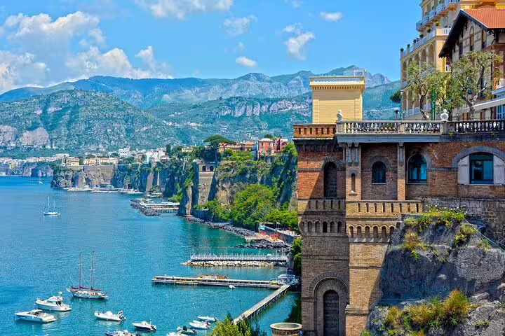 Private Amalfi Coast day tour from Sorrento with Sorrento cliffs, marina boats and panoramic coastline views