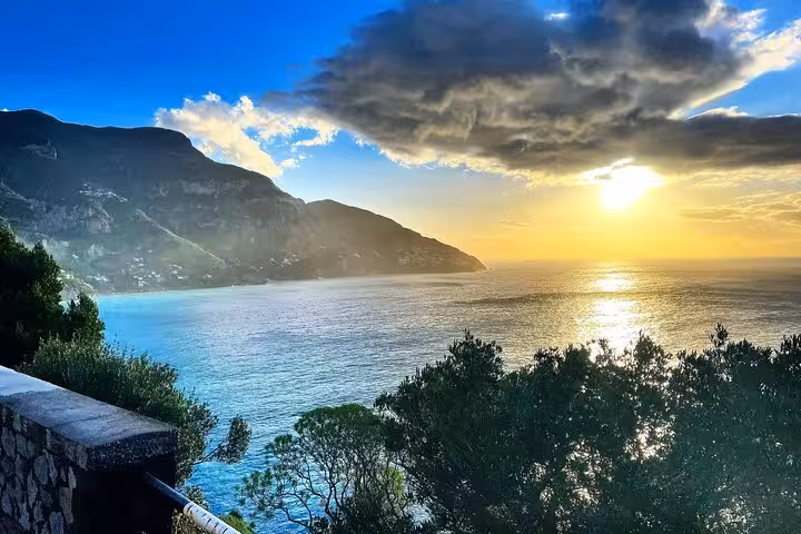Breathtaking Amalfi Coast sunset view with dramatic cliffs and serene sea for private tour experience.