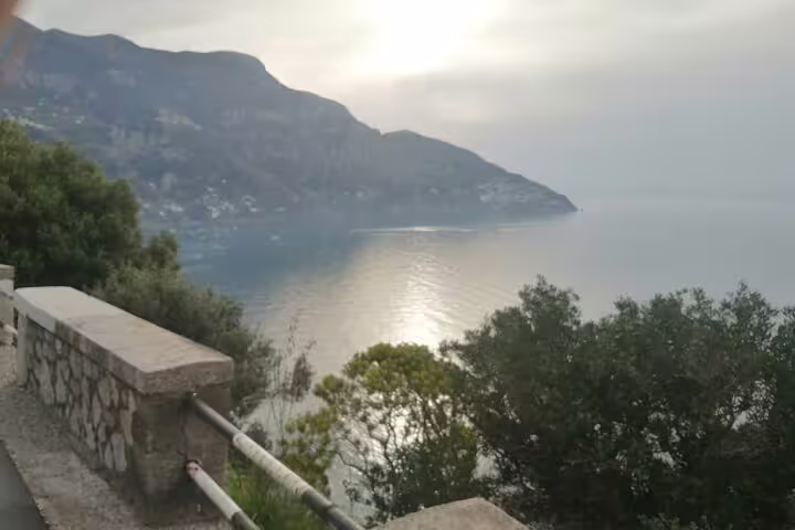 Sunset over the Amalfi Coast seen from a coastal road between Ravello and Positano on a shared small-group tour