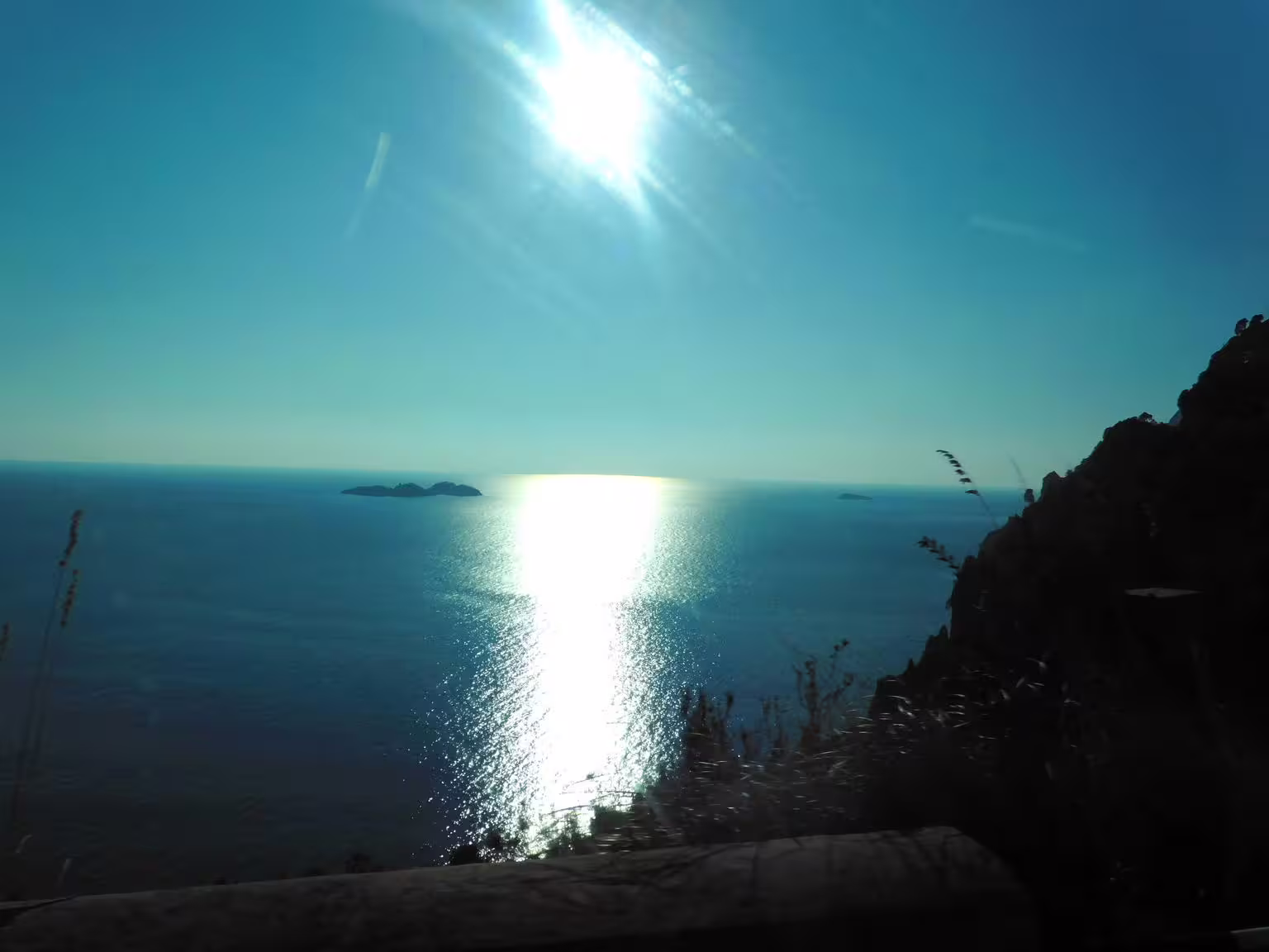 Sunlit Tyrrhenian Sea from Amalfi Coast road viewpoint, coastal scenery on Pompeii & Amalfi tour from Naples