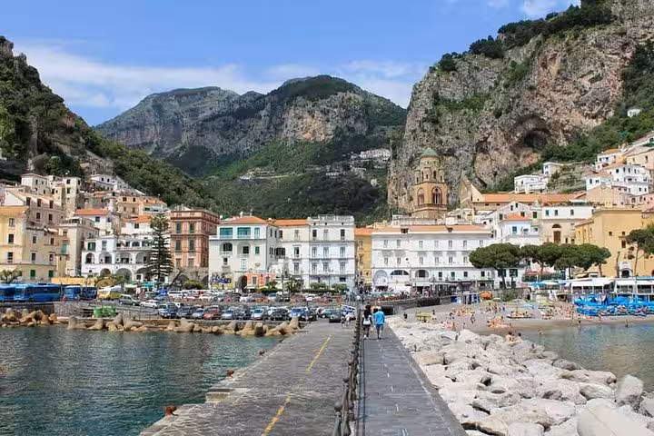 Charming Amalfi Coast village with vibrant buildings nestled between mountains and sea.