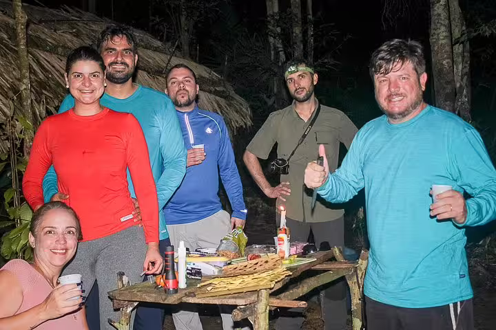 Group of adventurers enjoying a night in the Amazon rainforest at Tapiri Floating Lodge, surrounded by lush jungle.
