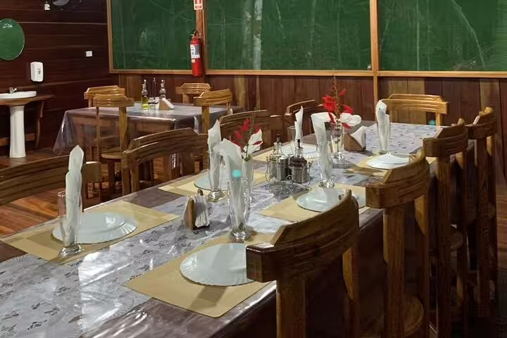 Charming dining area with elegantly set tables at Amazon Mamori Lodge, perfect for an authentic jungle dining experience.