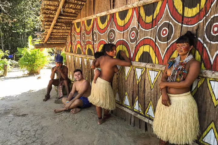 Local community near Tapiri Rio Negro Lodge showcasing traditional attire and vibrant Amazonian art.