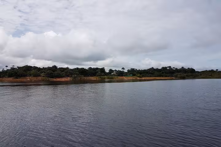 Wide Amazon River view under cloudy sky, scenic waterway cruise on a 5-day Amazon jungle adventure tour