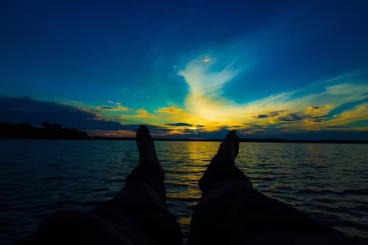 Relaxing view of a serene Amazon sunset from a boat, highlighting the tranquility of the Mamori lodge experience.