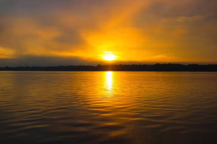 Stunning Amazon sunset view from Mamori Lodge, reflecting golden hues on the serene river waters.