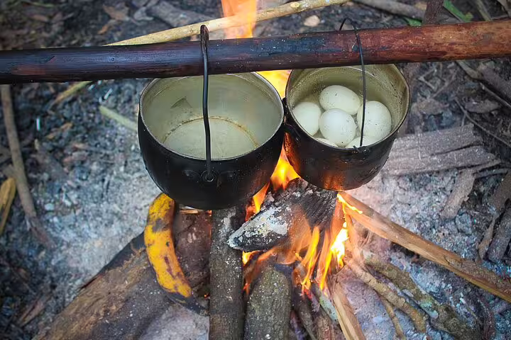 Campfire cooking with pots at Amanã Lake, perfect for a 7-day Amazon deep survival adventure.