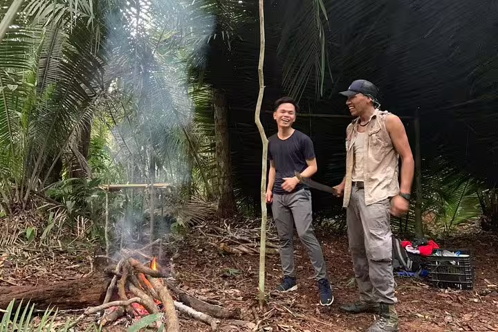 Tour participants enjoying a campfire setup in the Amazon rainforest.