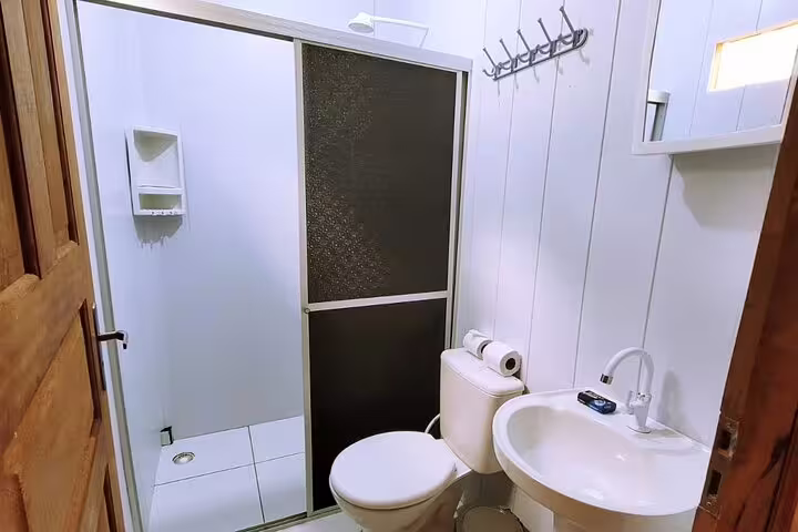 Modern bathroom at Amazon Tapiri Floating Lodge featuring shower and essential amenities for a comfortable stay.