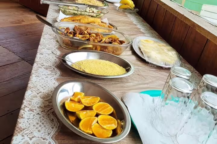 Buffet-style dining experience at Amazon Tapiri Floating Lodge with fresh fruits and local dishes.