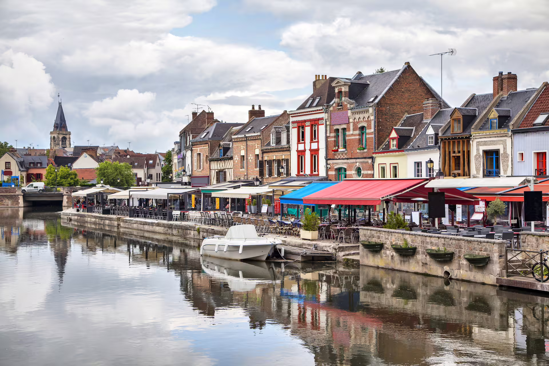 Quayside cafés and colorful houses on Amiens canal, key stop on the Amiens 1-day walking audioguide tour