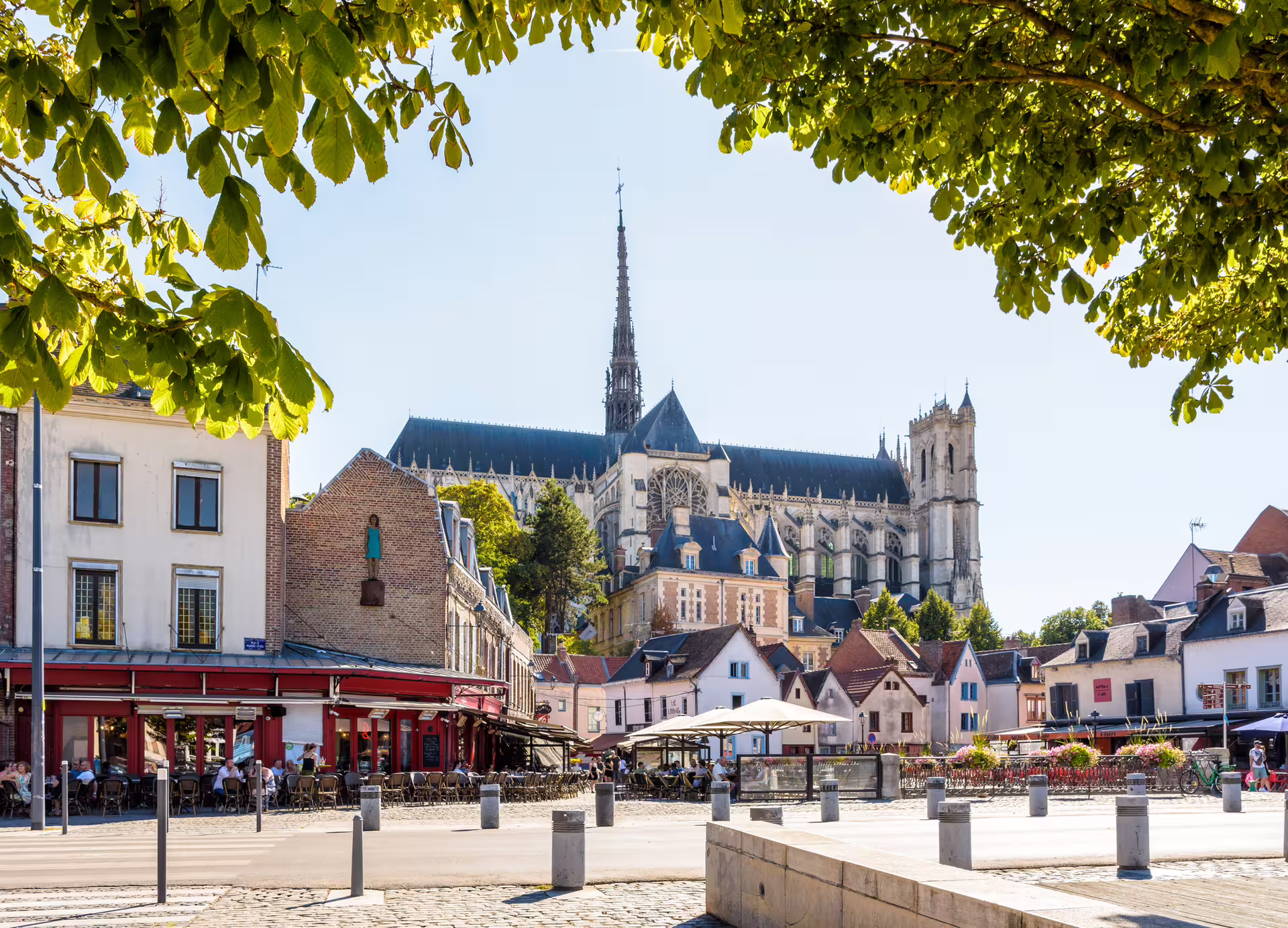 Amiens Cathedral skyline over riverside cafes, highlight of the 1-day walking tour with audioguide in 7 languages