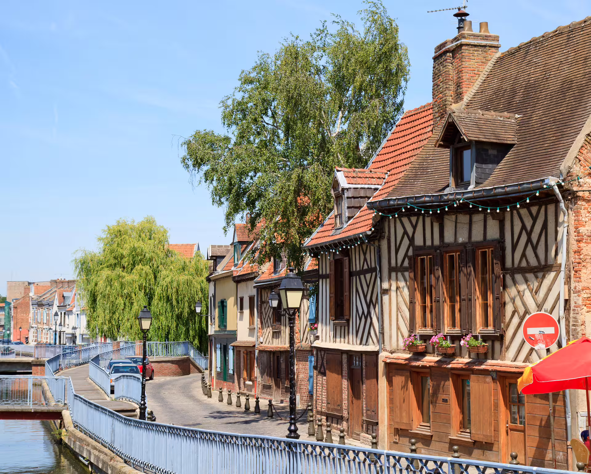 Half-timbered houses along the Somme canal in Amiens, scenic route on a 1-day walking tour with audioguide