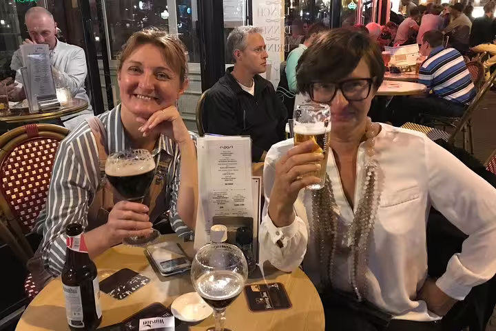 Guests enjoy Dutch beer at a cozy Amsterdam café, a tasty stop on a private bike market tour