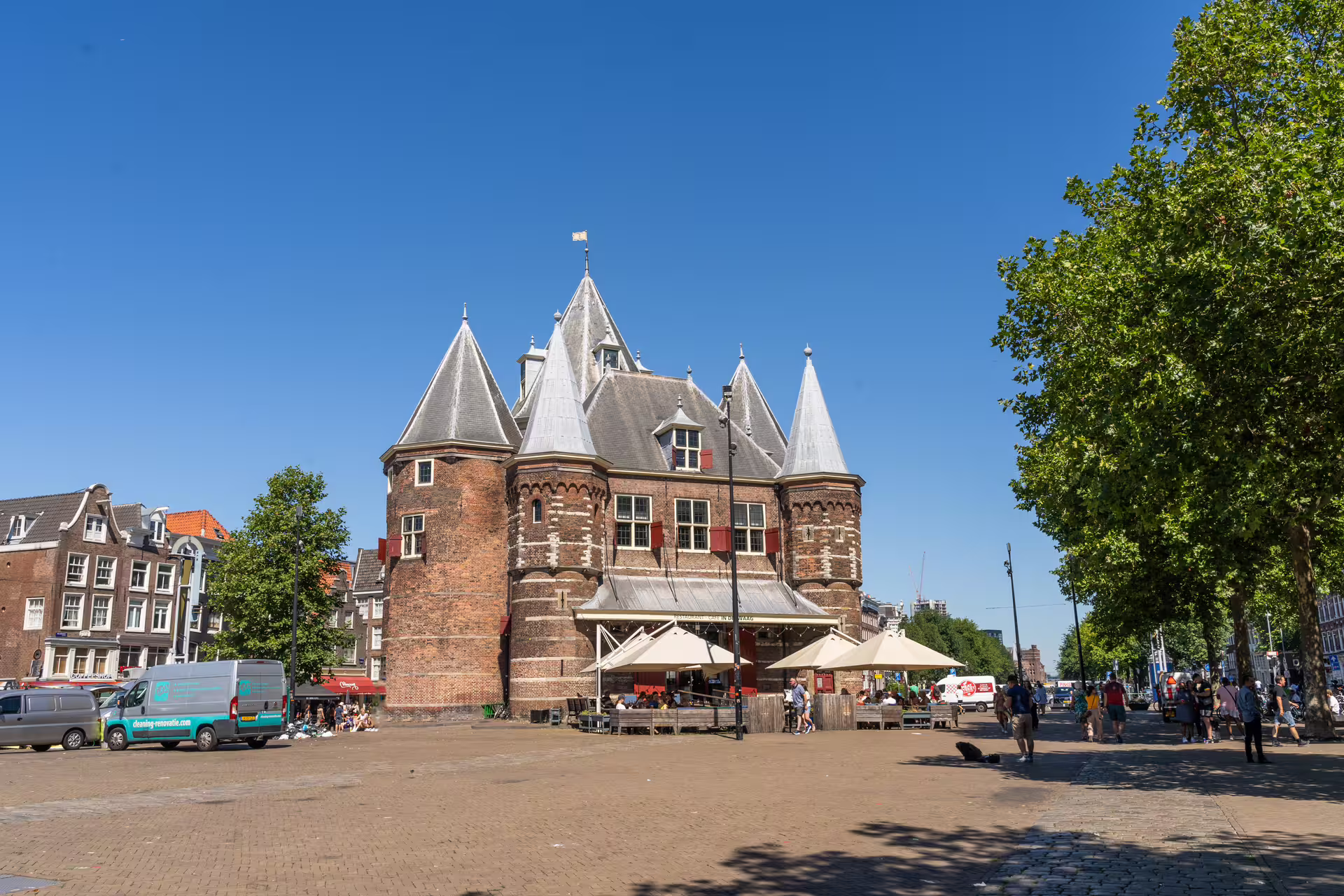Historic Amsterdam building under a clear blue sky, perfect for walking tours and canal cruise with unlimited drinks.