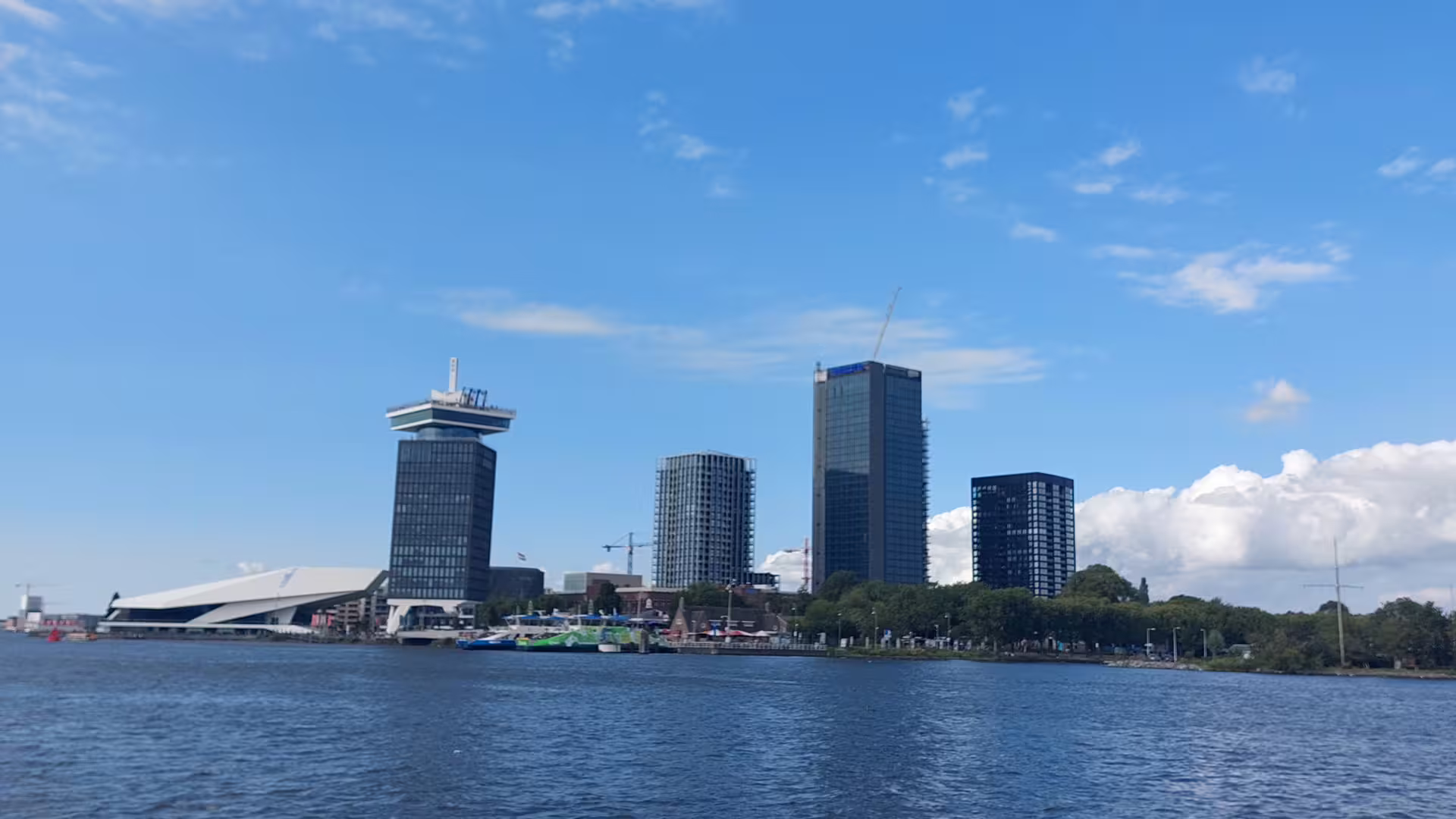 Amsterdam waterfront skyline view on canal cruise during 4-hour layover tour near Central Station