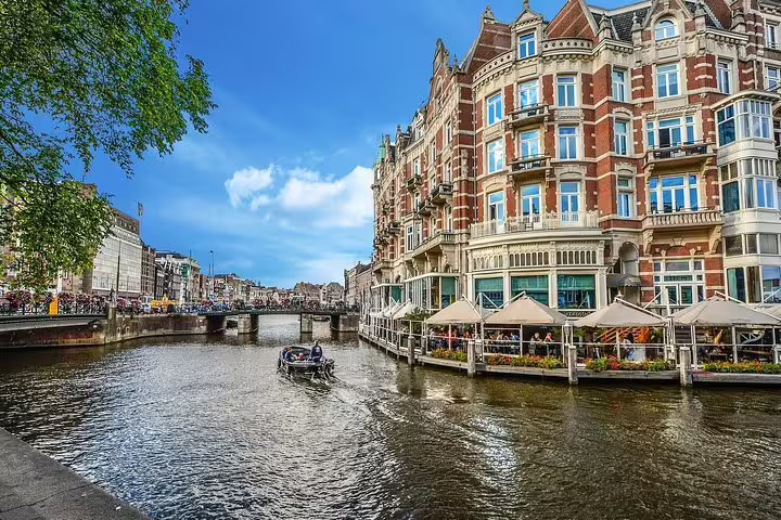 Picturesque canalside view with historic buildings in Amsterdam, essential on private 2-hour sightseeing tours.
