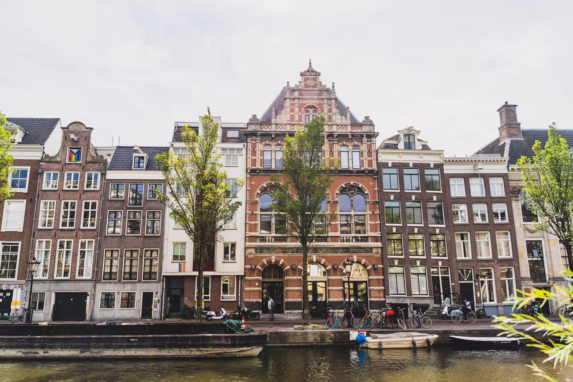 Scenic view of Amsterdam's historic canal houses, perfect for a walking tour with cheese tasting experience.
