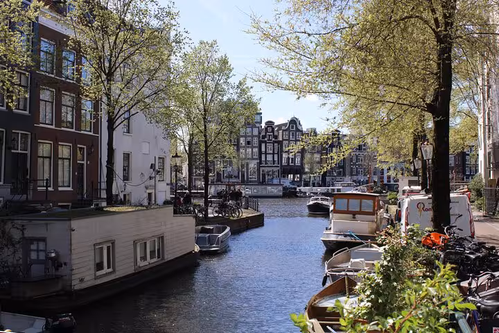 Canal scene with boats and bicycles in Amsterdam, perfect for a private city walking experience with a local