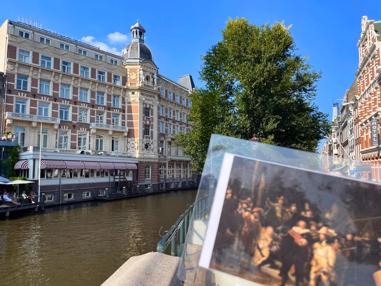 Amsterdam canal view with historic hotel, featured stop on Rembrandt & Van Gogh walking tour in the city center