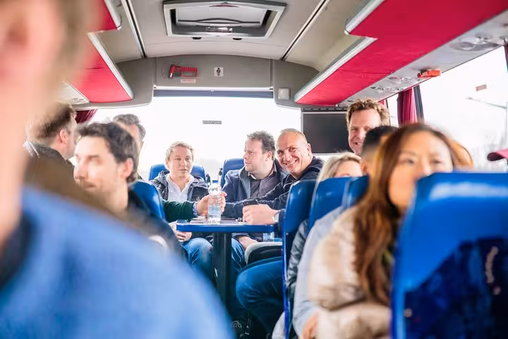 Guests socializing on bus between Amsterdam craft beer breweries, brewery tour transport with tastings included