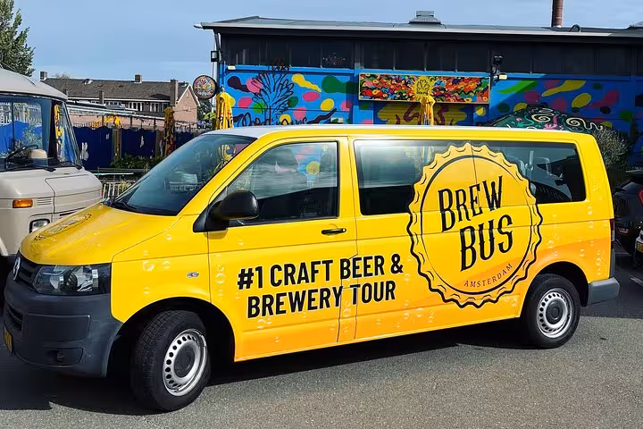 Yellow Brew Bus parked outside Amsterdam brewery, craft beer brewery tour by bus with tastings
