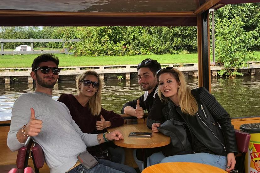 Travelers enjoying canal boat ride in Giethoorn, Netherlands, part of Amsterdam Zaanse Schans Volendam tour