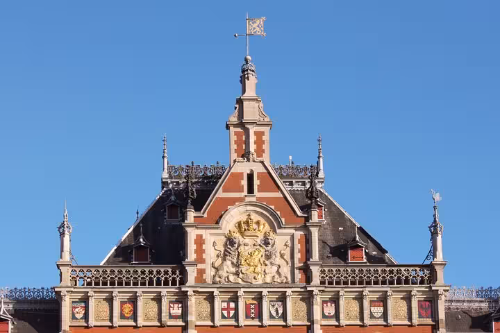 Historic Amsterdam landmark facade with ornate crest, featured on a private city walking experience with a local