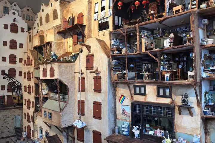 Miniature canal house dollhouse display in Amsterdam Jordaan, a charming stop on a half-day private walking tour