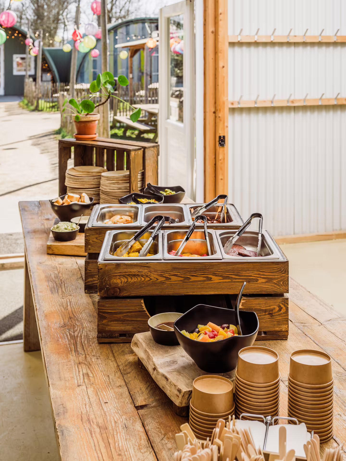 Catering buffet table at Amsterdam laser tag arena with snacks, sauces and eco cups for birthday parties