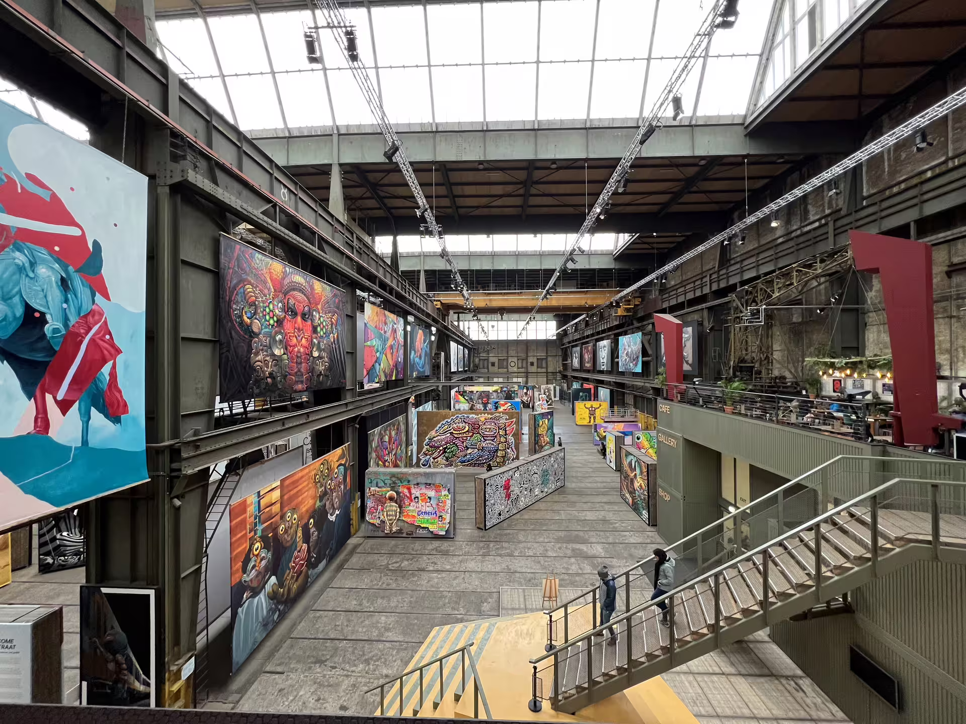 Explore vibrant street art at Amsterdam's NDSM Wharf, featuring colorful murals and industrial architecture on a private tour.