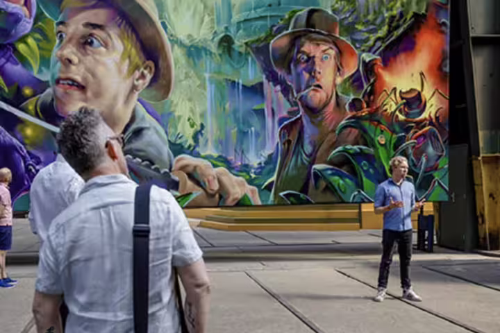 Visitors admire vibrant street art mural during a private tour at Amsterdam's NDSM Wharf, highlighting local creativity.