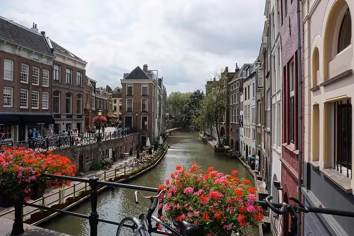 Utrecht canal with flowers and bicycles, perfect arrival view on Amsterdam or Schiphol Airport to Utrecht transfer