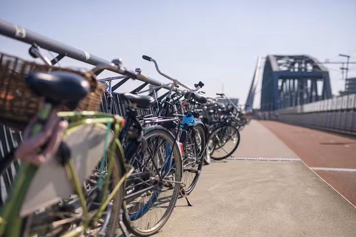 Bicycles on a Dutch bridge in Amsterdam, highlighting comfortable private transfer from Amsterdam or Schiphol to Nijmegen