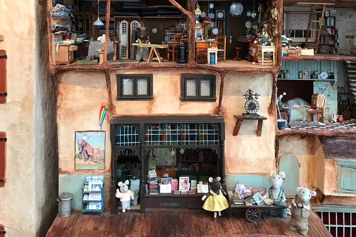 Whimsical Amsterdam shop window with mini figures and books, ideal for Your Own Amsterdam random adventure tour