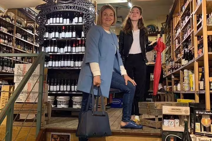 Guests explore an Amsterdam specialty shop with craft bottles on Amsterdam’s Unexpected Treasures tour