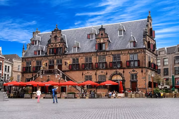 Historic Dutch square in Amsterdam, ideal pickup point for private transfer from Schiphol Airport to Nijmegen