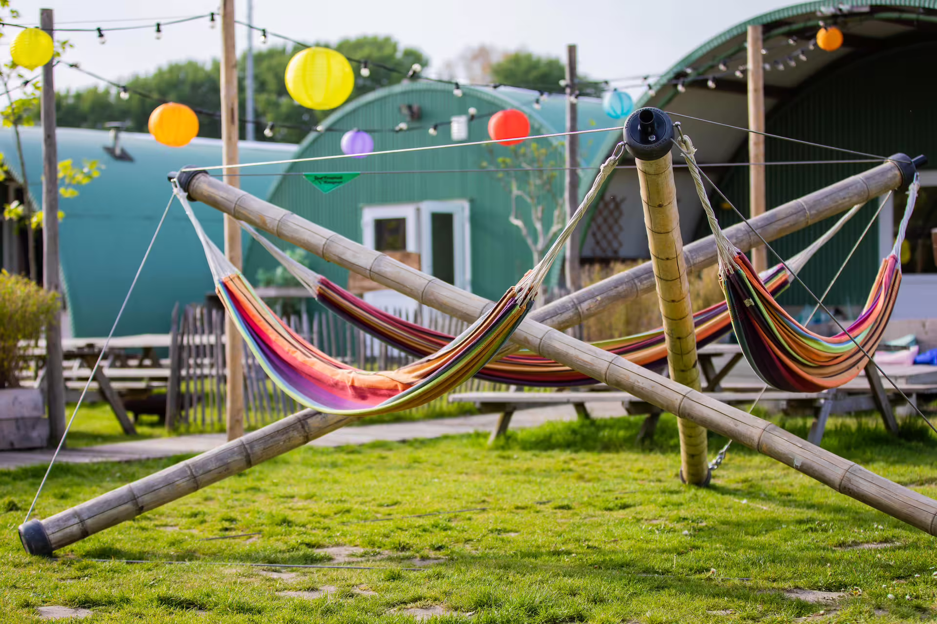Colorful hammocks and lantern lights at an outdoor lounge area near Amsterdam Free Roam VR experience