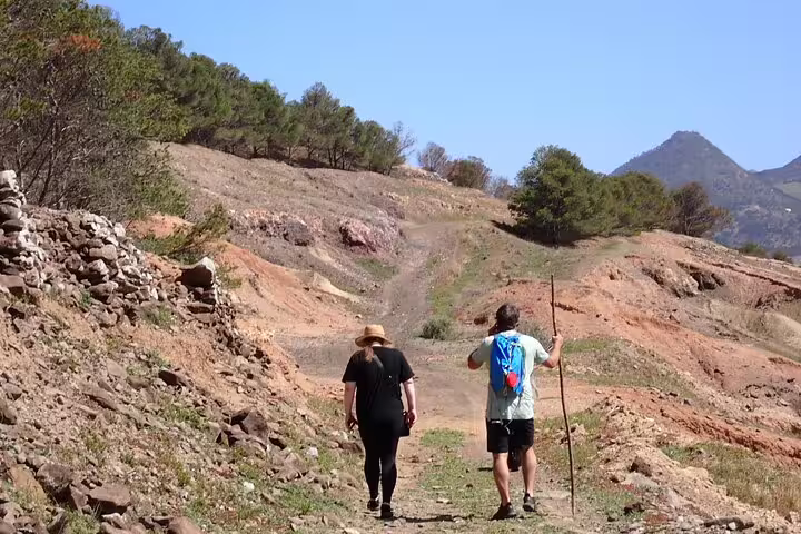 Hikers explore rugged trails and scenic views during the Ana Ferreira Caves & Peaks Trek under a clear blue sky.