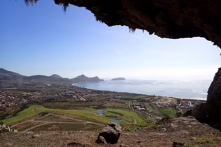Scenic view from Ana Ferreira caves overlooking Porto Santo's lush landscape and coastline, perfect for trekking enthusiasts.