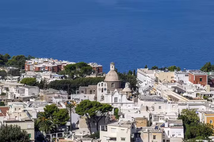 Aerial view of Anacapri with historic architecture and ocean backdrop, perfect for a guided tour from Sorrento.
