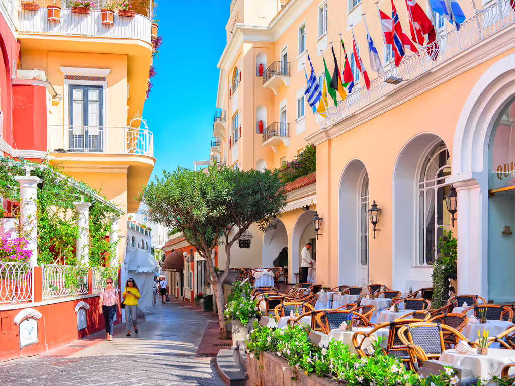 Anacapri street scene with pastel buildings and cafes, included on small group Capri and Anacapri tour from Naples