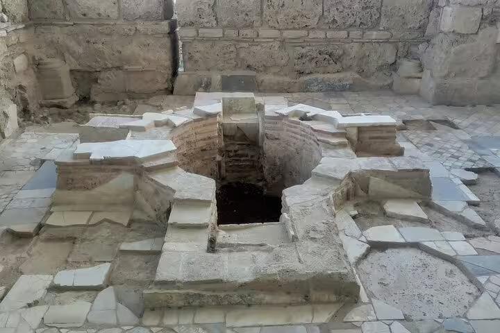 Ancient stone baptismal pool in early Christian ruins on Seven Churches of Asia Minor tour in Turkey