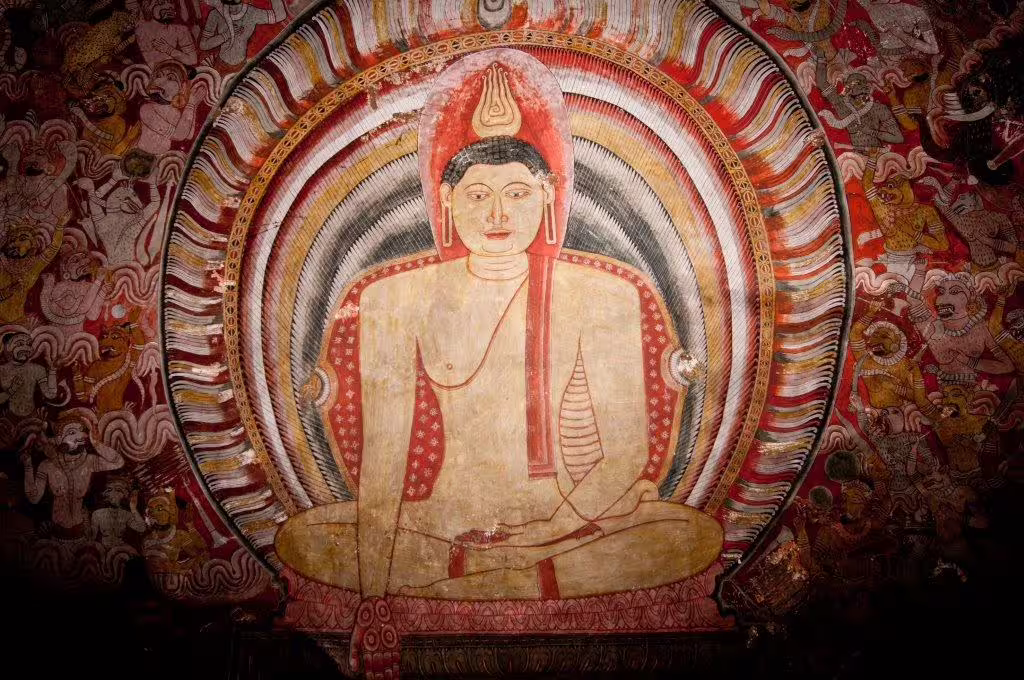 Intricate ancient mural of a seated Buddha surrounded by vibrant colors in a historic Sri Lankan temple, showcasing cultural heritage.
