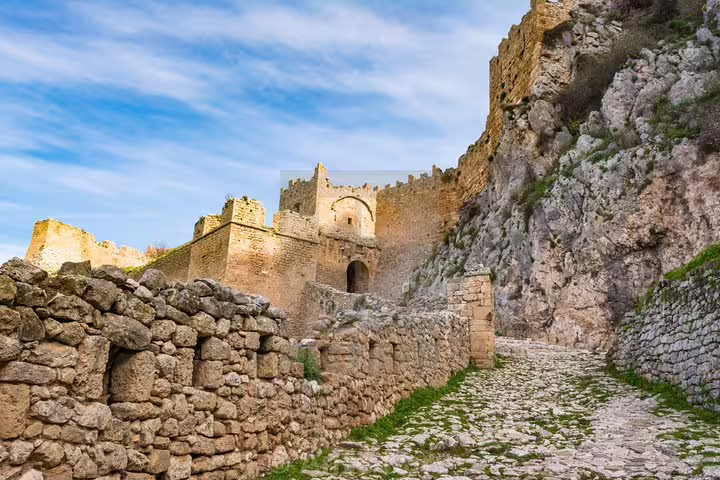 Stone path leading to Acrocorinth fortress walls above Ancient Corinth, scenic stop on a half-day guided tour