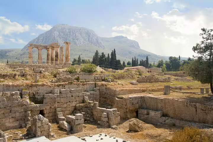 Ancient Corinth archaeological site with Apollo temple columns and mountain views on a 2-day Peloponnese tour
