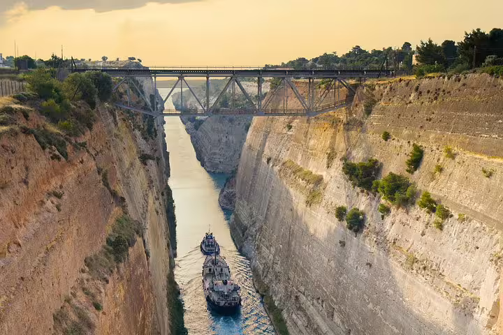 Corinth Canal viewpoint with ship below and bridge above, key stop on an Ancient Corinth half-day tour