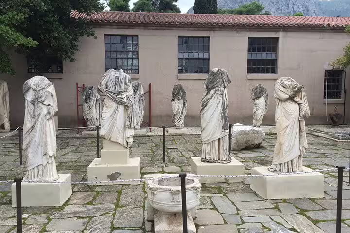 Headless marble statues in Ancient Corinth museum courtyard on Corinth Canal and Nafplio day tour